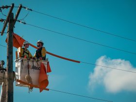 Two Electricians Working on Utility Pole